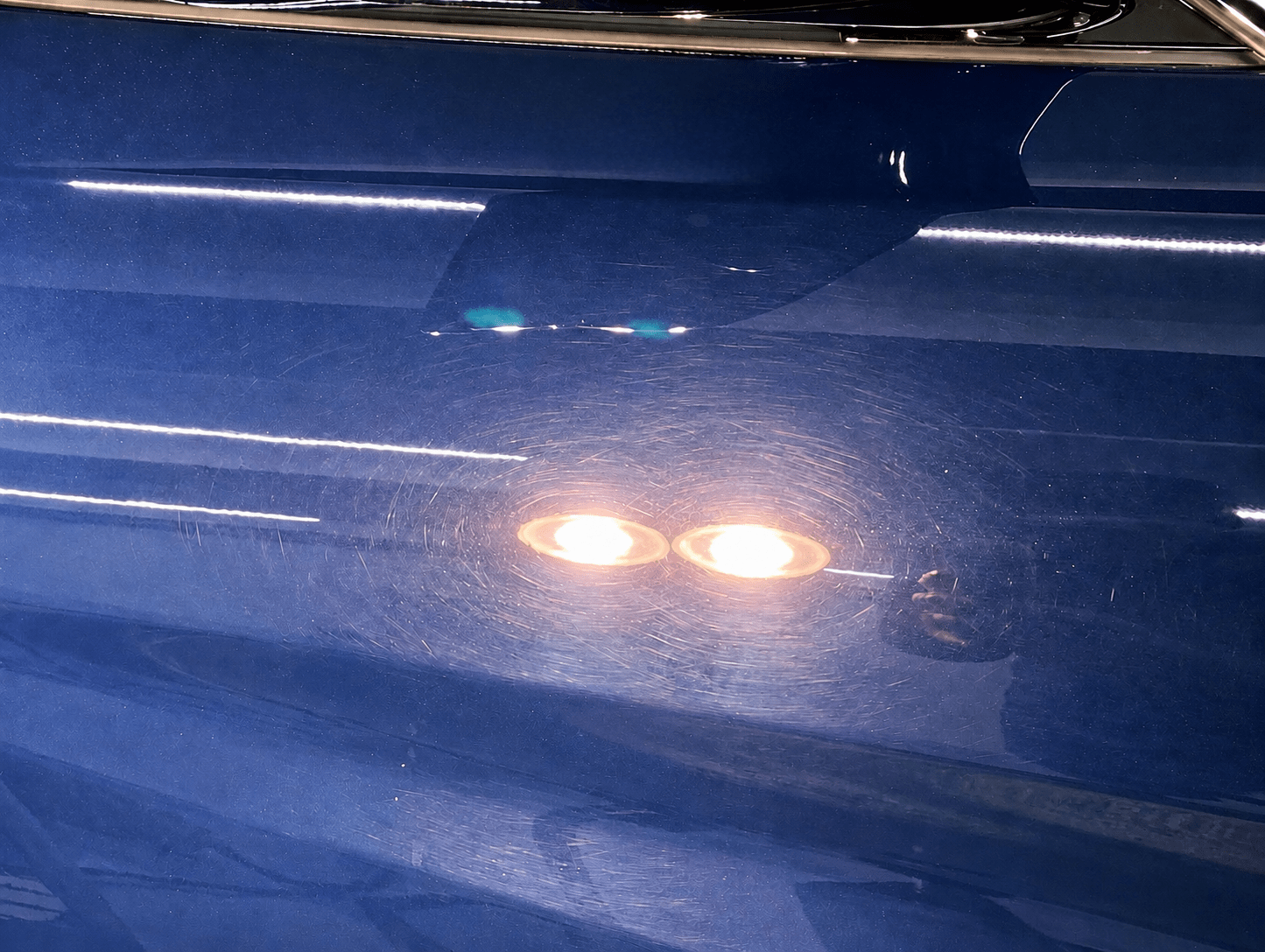 Swirl marks and paint defects on blue automotive paint before correction in Fort Lauderdale