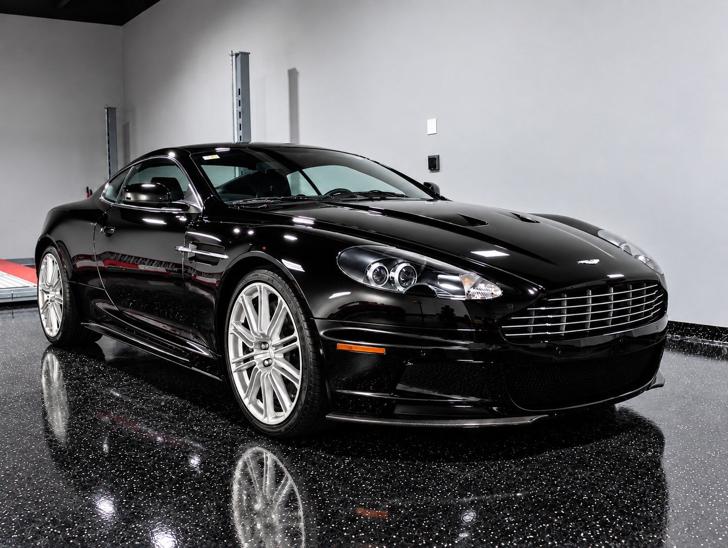 Glossy black Aston Martin after professional paint correction in Fort Lauderdale