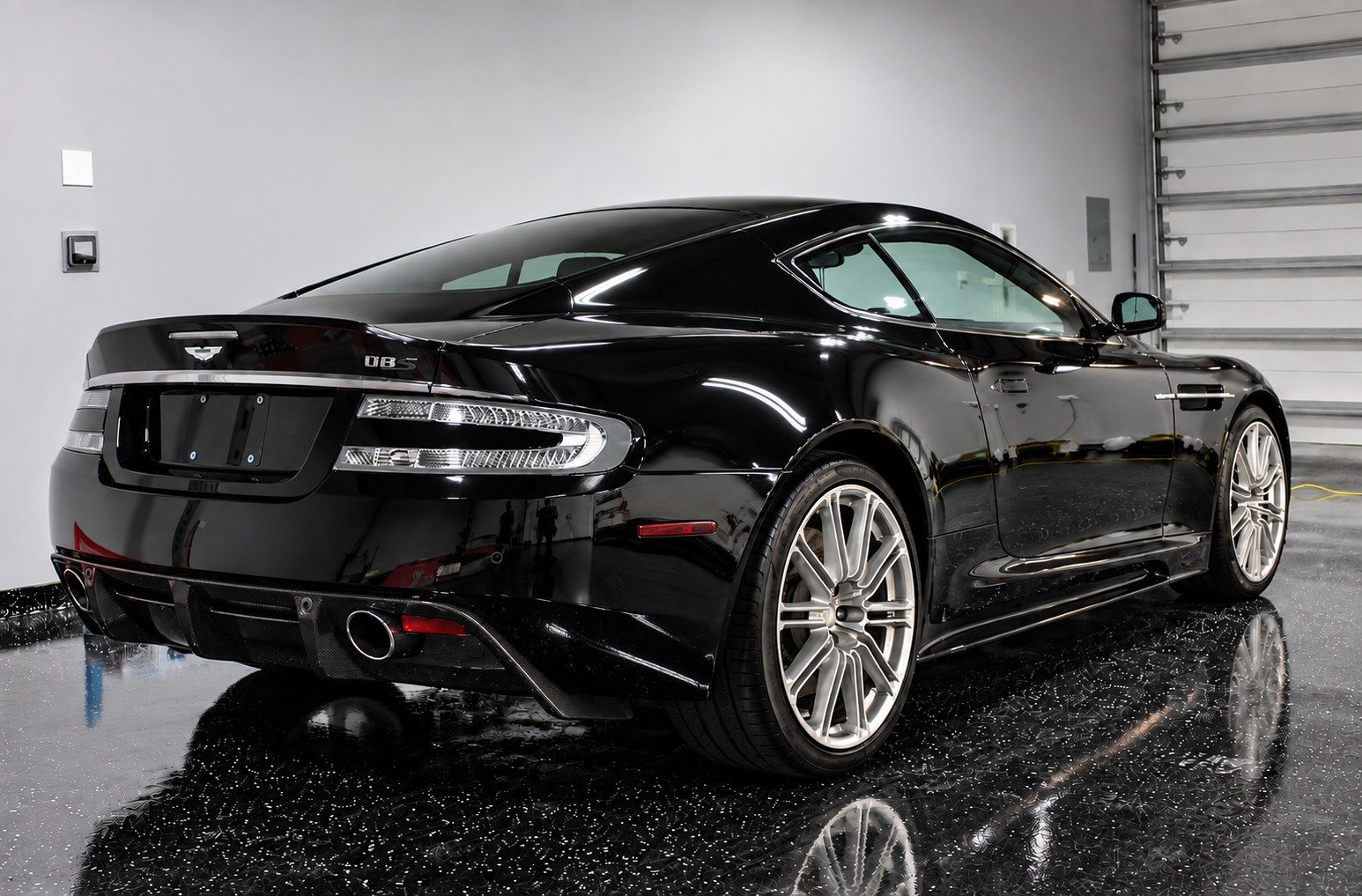 Glossy black Aston Martin rear after professional paint correction in Fort Lauderdale