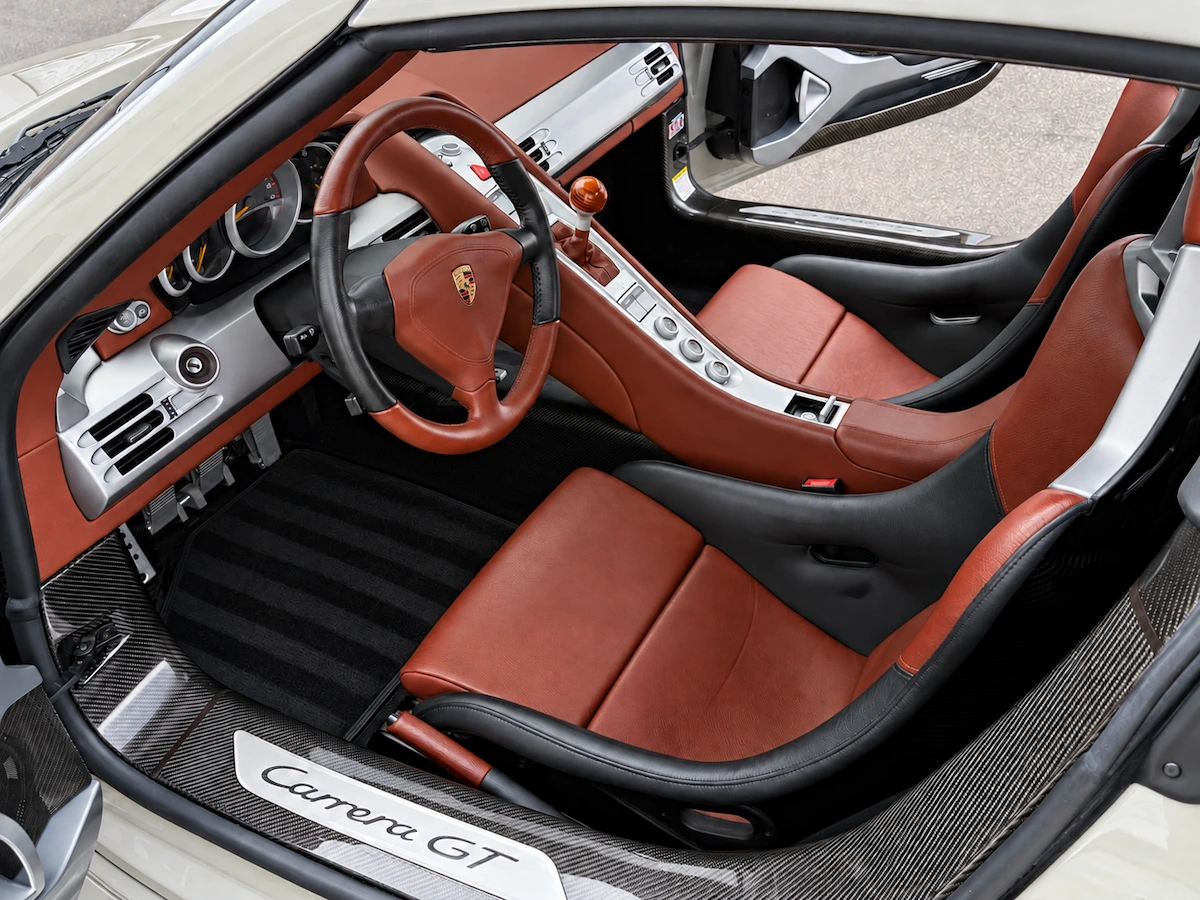 Red leather seats and steering wheel inside a Porsche Carrera GT
