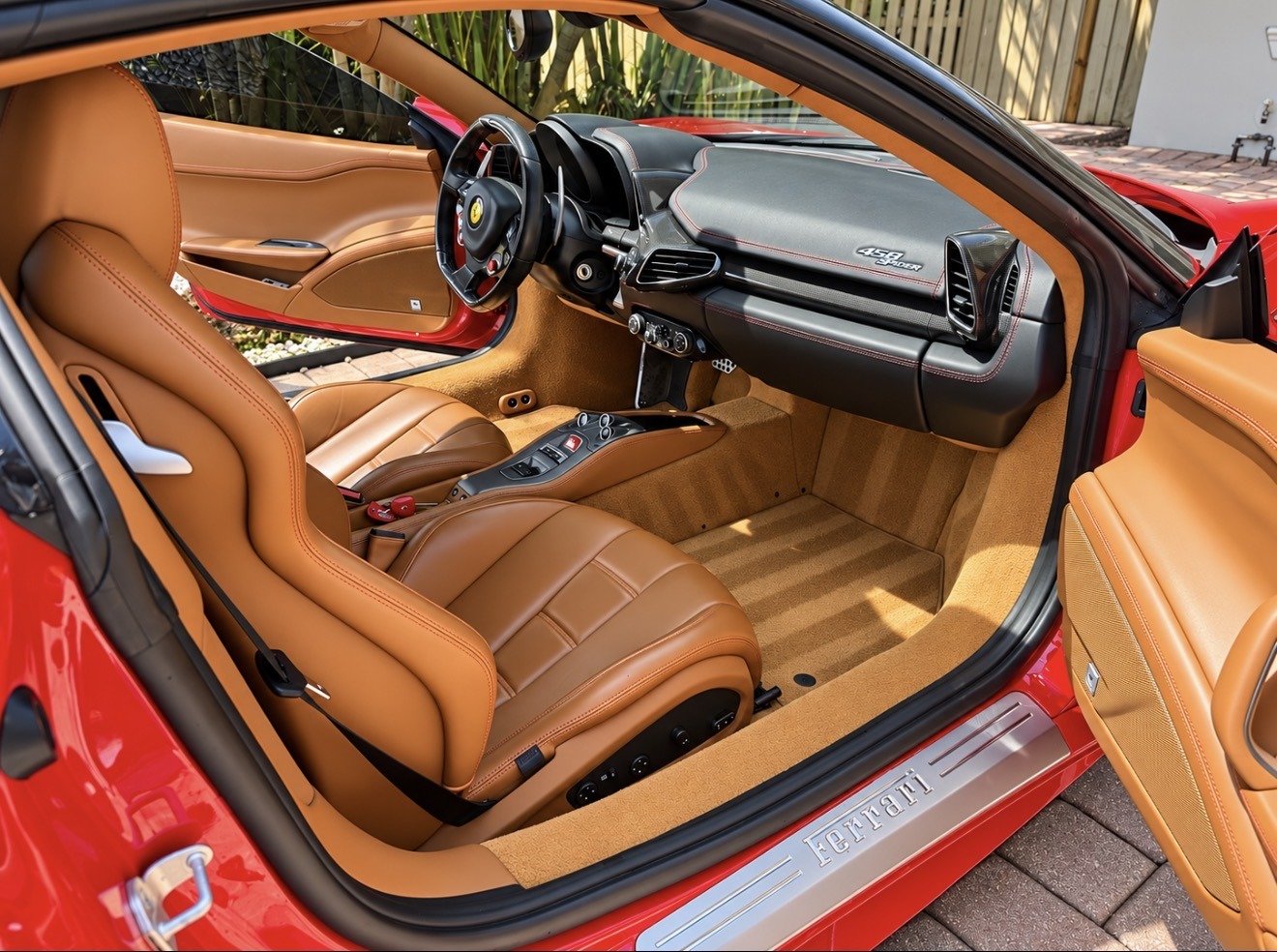 Tan leather seats and dashboard inside a Ferrari