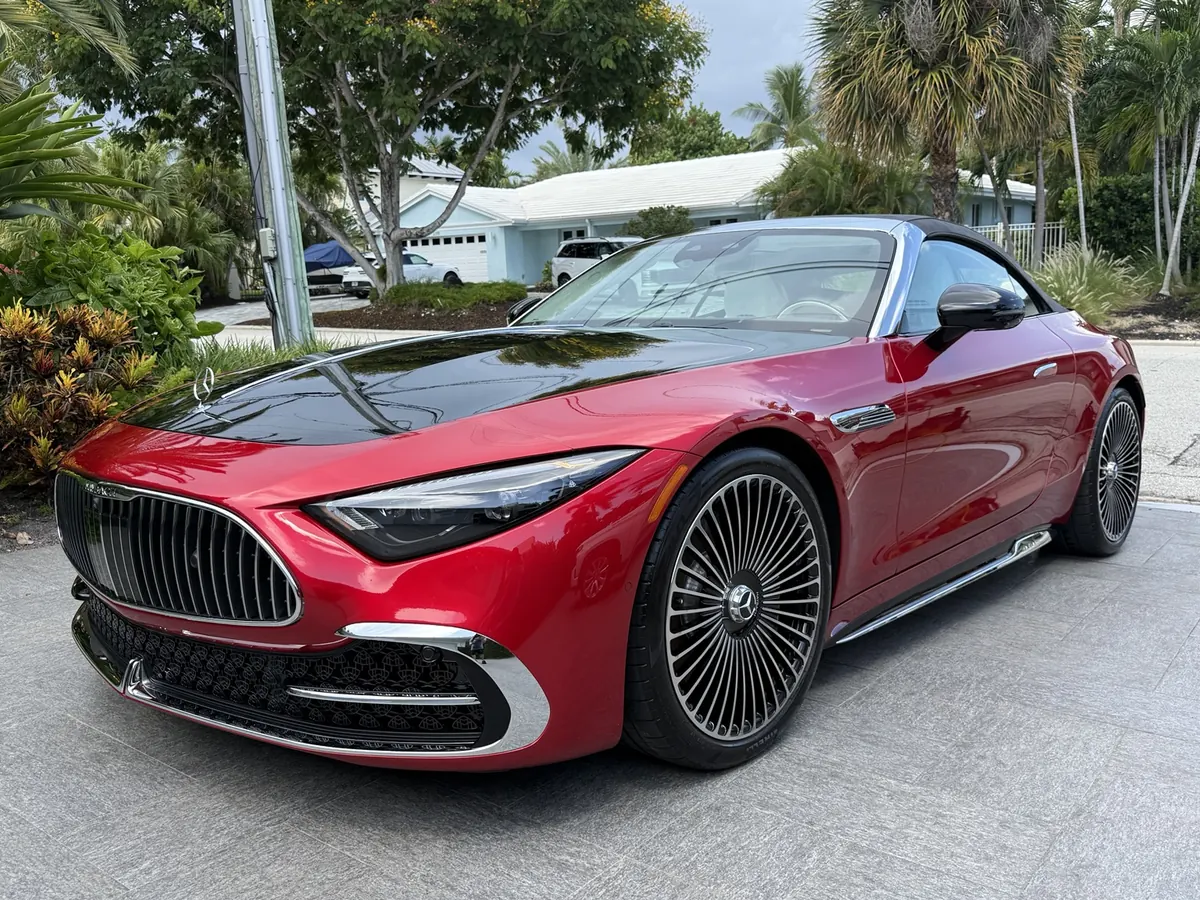 Red Mercedes convertible with a black hood and polished wheels
